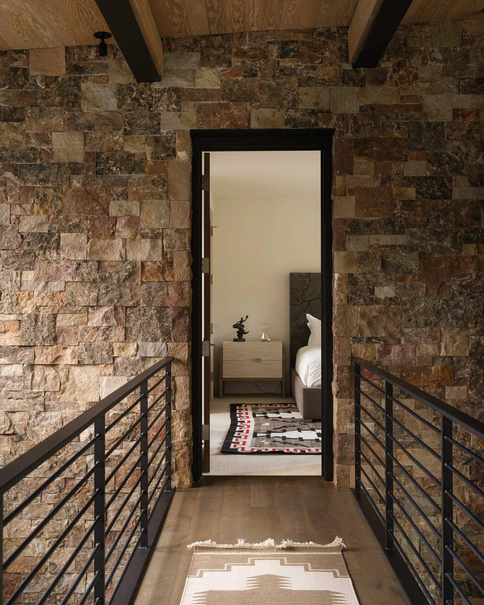 Catwalk hallway view into a guest bedroom — architectural photography Big Sky Montana, Reid Smith Architects